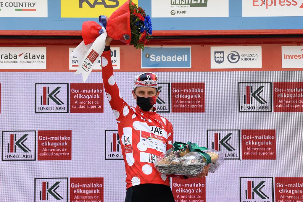 ONDARROA SPAIN APRIL 09 Podium Tadej Pogacar of Slovenia and UAE Team Emirates Polka Dot Mountain Jersey Celebration during the 60th ItzuliaVuelta Ciclista Pais Vasco 2021 Stage 5 a 1602km stage from Hondarribia to Ondarroa Trophy Mask Covid Safety Measures itzulia ehitzulia on April 09 2021 in Ondarroa Spain Photo by David RamosGetty Images