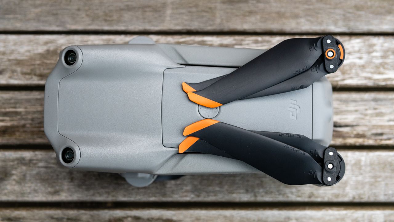 A folded DJI Air 2S drone on a wooden table