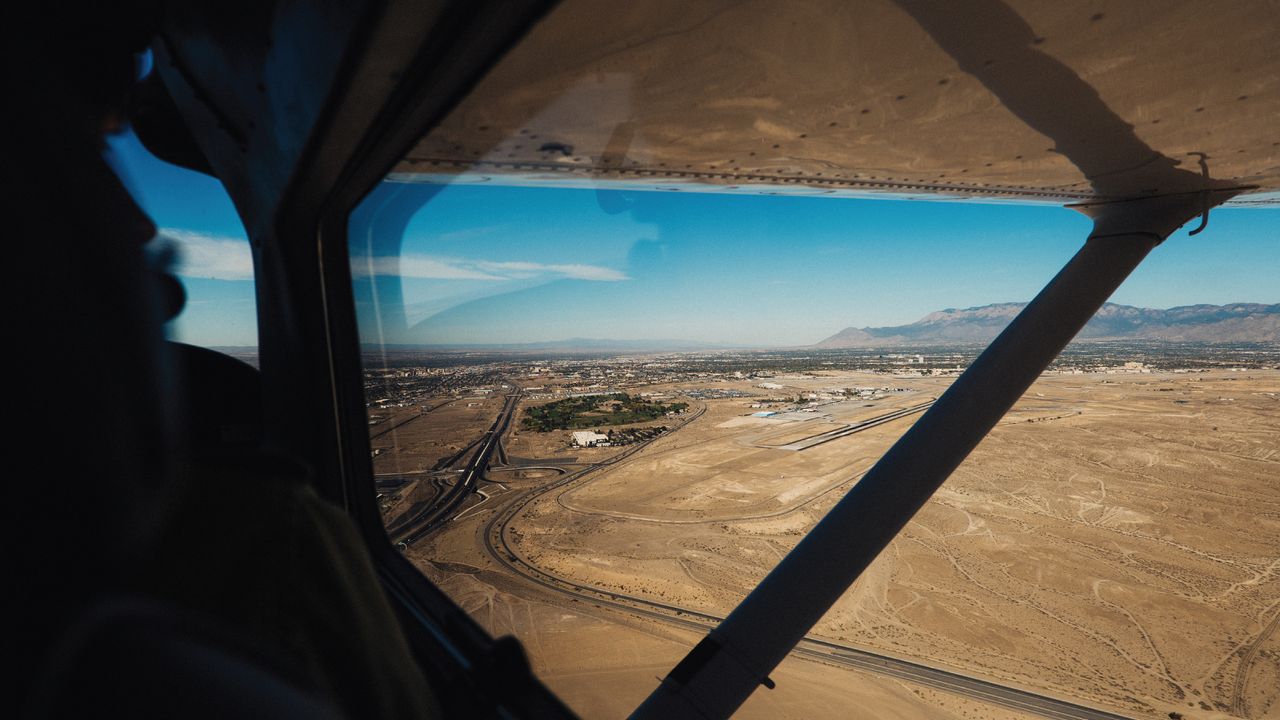 Barren land from a small airplane window.