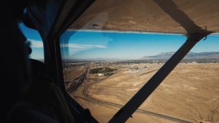 Aerial viewpoint from airplane looking down on plains and streets