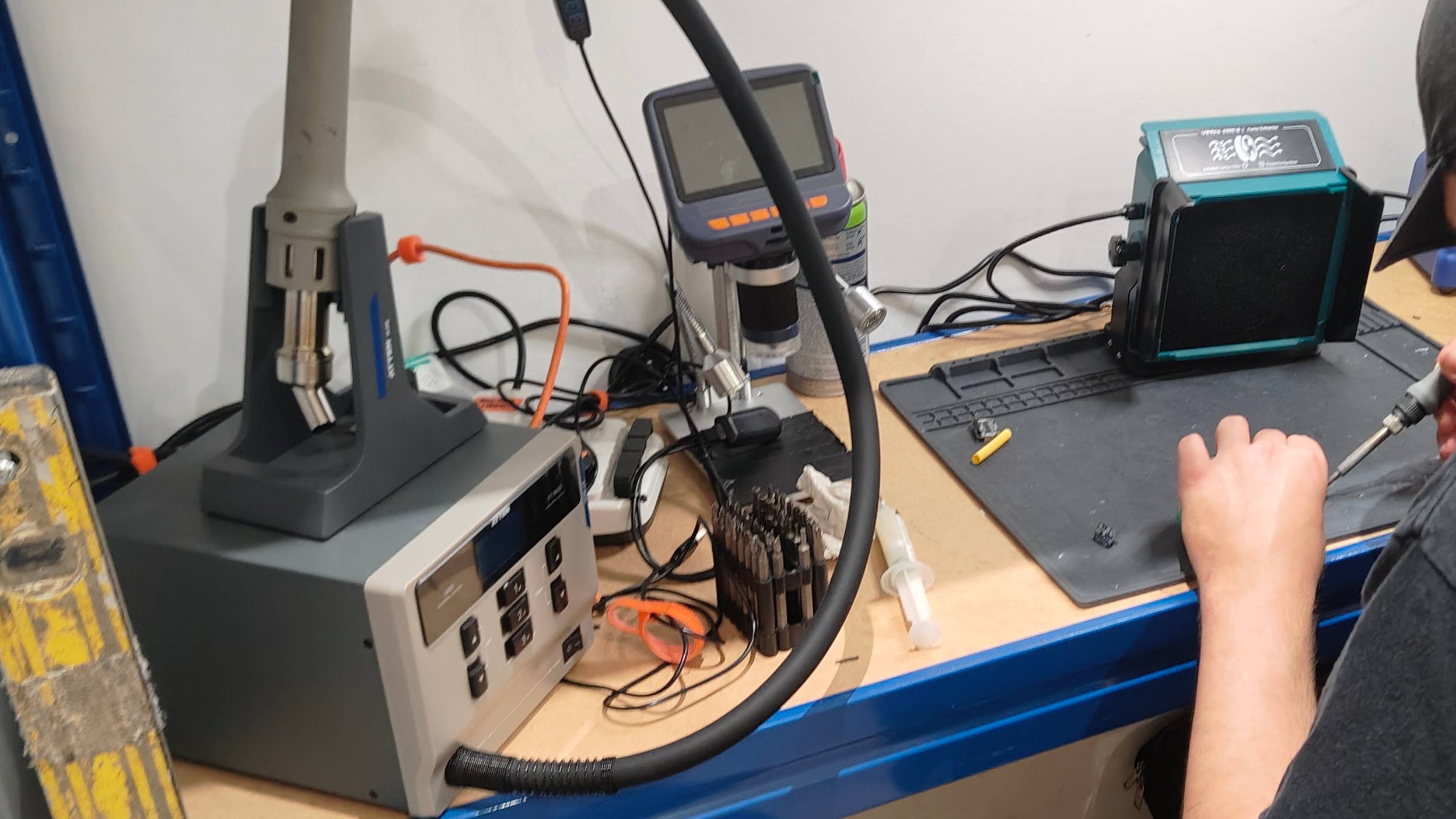 A desk full of soldering and tech repair kit.
