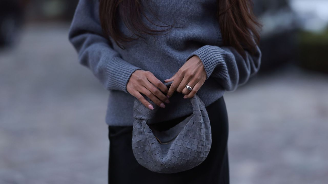 grey jumpers - woman wearing grey wool jumper and bottega bag 1776461363