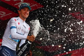 Team Bahrain's Italian rider Antonio Tiberi celebrates the best young rider's white jersey on the podium of the 11th stage of the 107th Giro d'Italia cycling race, 207km between Foiano di Val Fortore and Franca Villa al Mare, on May 15, 2024. (Photo by Luca Bettini / AFP)