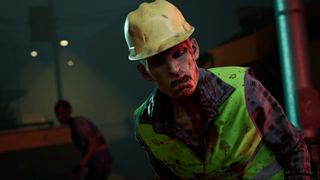 A zombified construction worker wearing a hard hat and hi-vis vest stares into the camera 