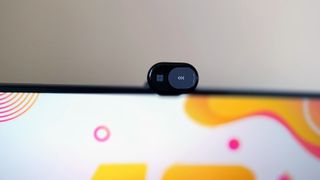 A black Microsoft Modern Webcam perched on a monitor