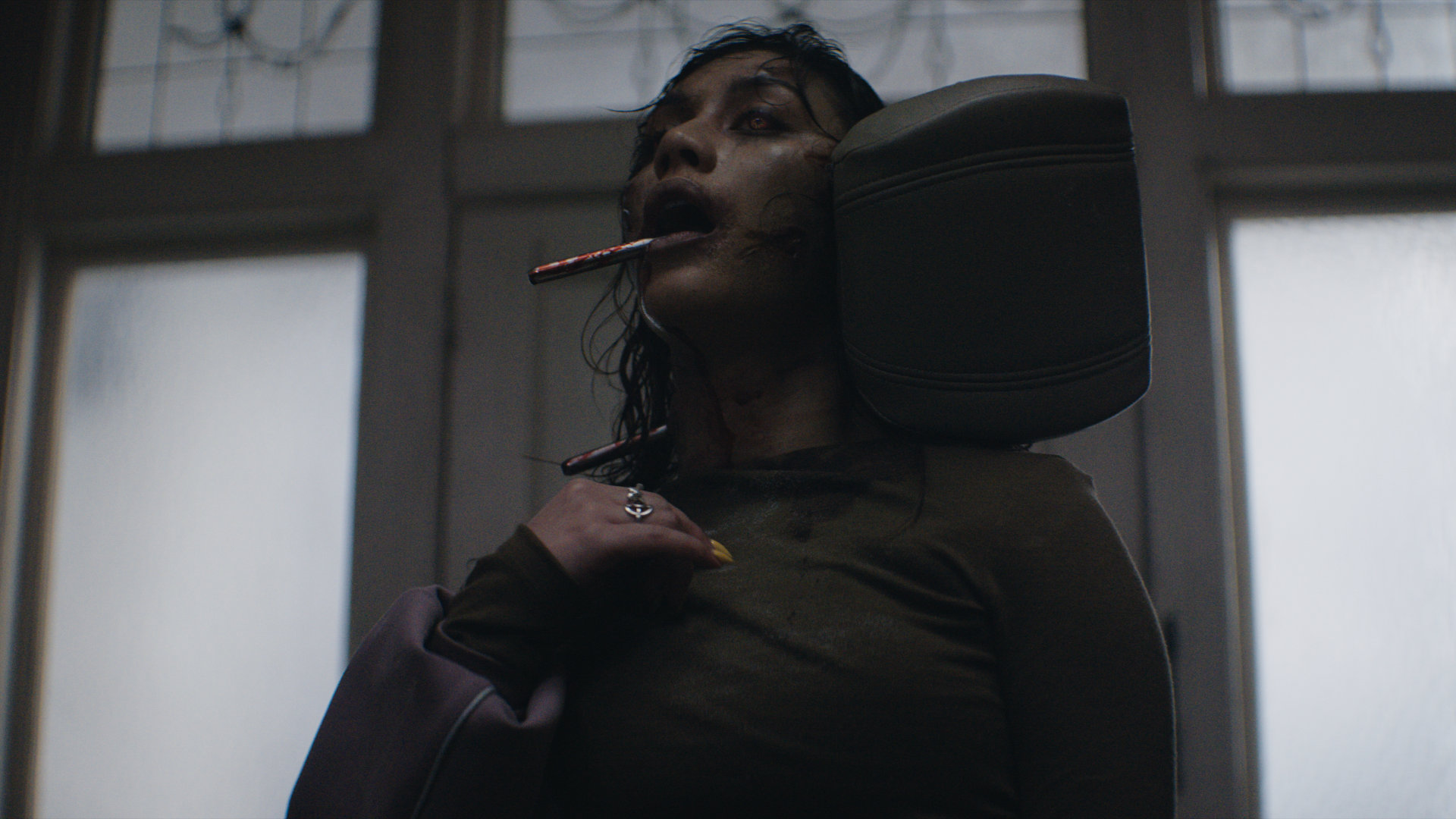 A woman with a car headrest stuck through her head.
