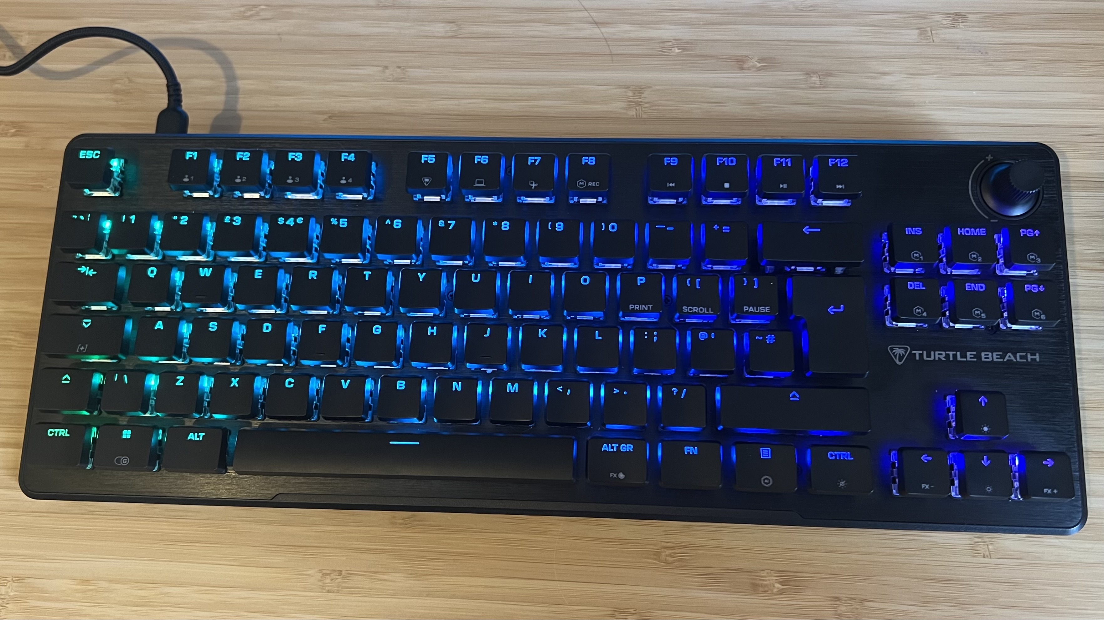 Turtle Beach Vulcan II TKL gaming keyboard on a wooden desk