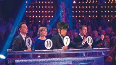 Image of Dr Hutch holding up a 7 in Strictly Come Dancing judging line up