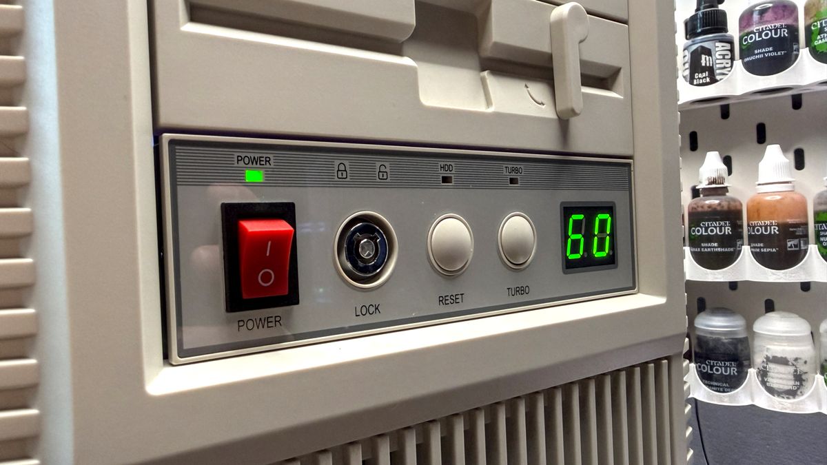 The retro-styled Silverstone FLP02 PC case as a PC is being built into it on a desk.