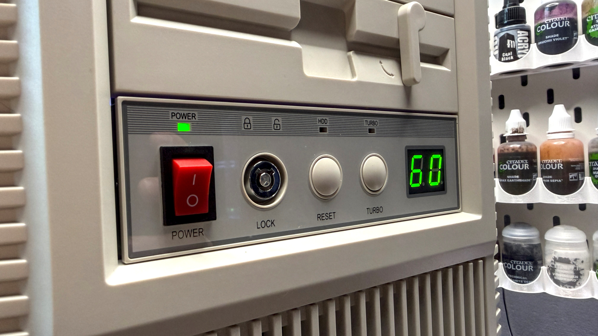 The retro-styled Silverstone FLP02 PC case as a PC is being built into it on a desk.