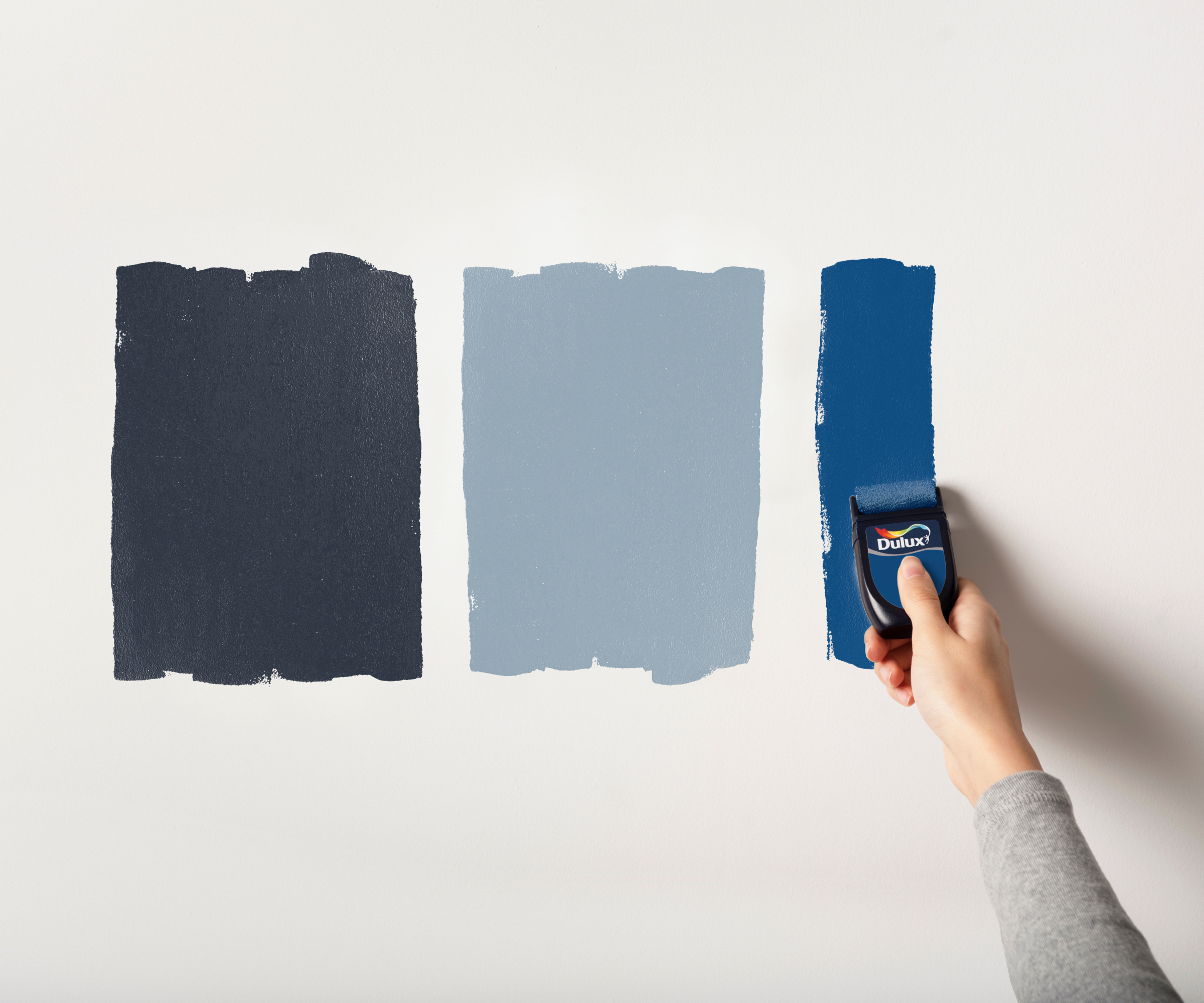 three shades of blue being tested on the wall