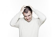a man scratching an itch