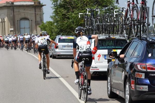 Riders at the team cars for bidons