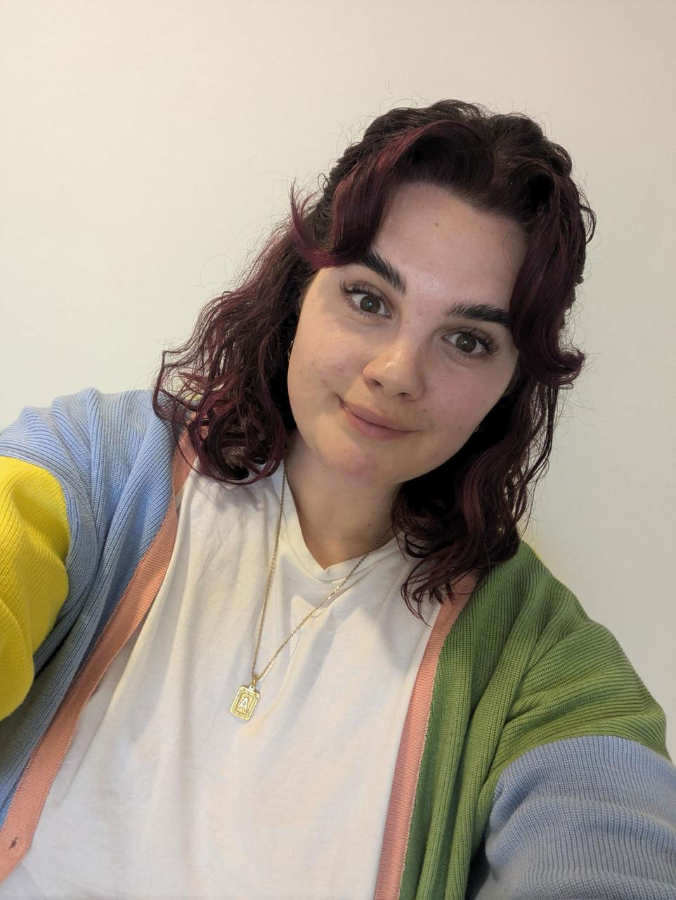 woman in colourful cardigan and white t-shirt