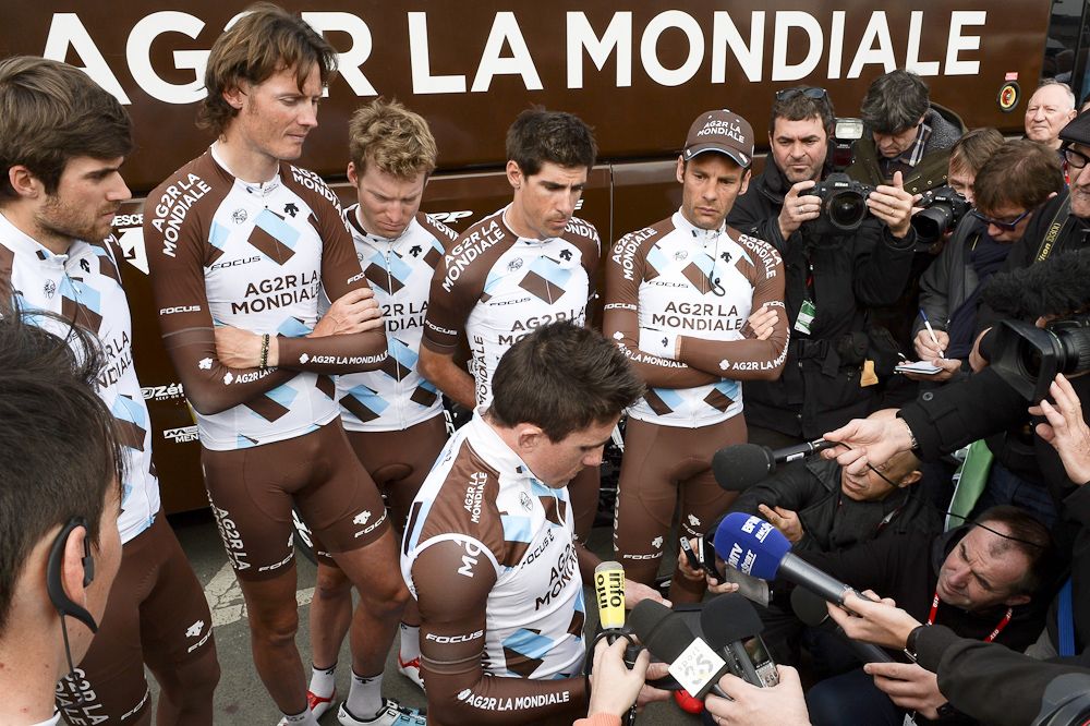 France's Samuel Dumoulin reads a statement to journalists, flanked by teammates of the France's AG2R La Mondiale cycling team.