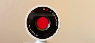 A white Poly Studio P5 webcam sitting on top of a monitor