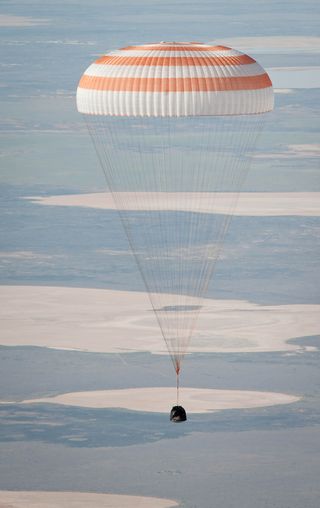 The Soyuz TMA-20 spacecraft is seen as it lands with Expedition 27 Commander Dmitry Kondratyev and Flight Engineers Paolo Nespoli and Cady Coleman in a remote area southeast of the town of Zhezkazgan, Kazakhstan, on Tuesday, May 24, 2011.