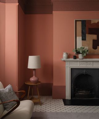 Living room with pink walls, dark pink lining, grey floors