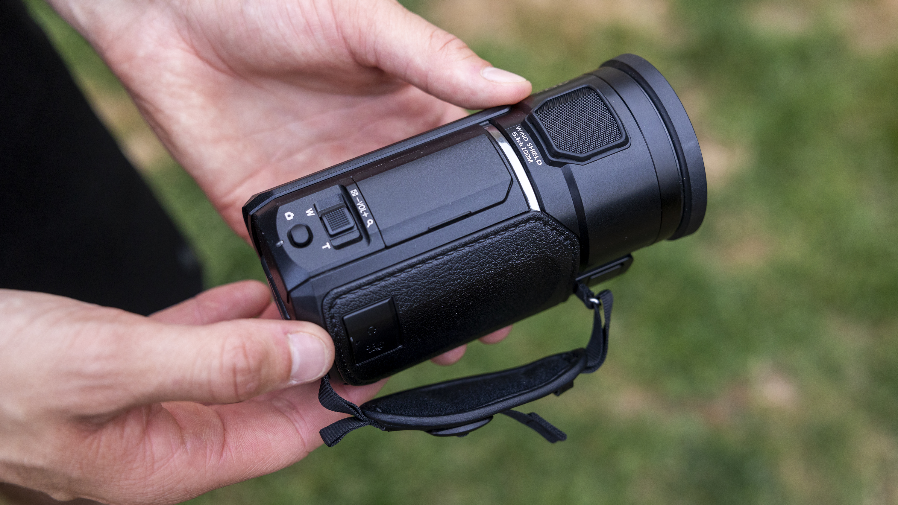 A male holding the Panasonic HC-V900 camcorder
