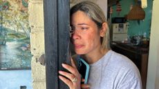 Heidy Sanchez cries after speaking to her daughter, who is in the U.S., during an interview at her home in Cuba