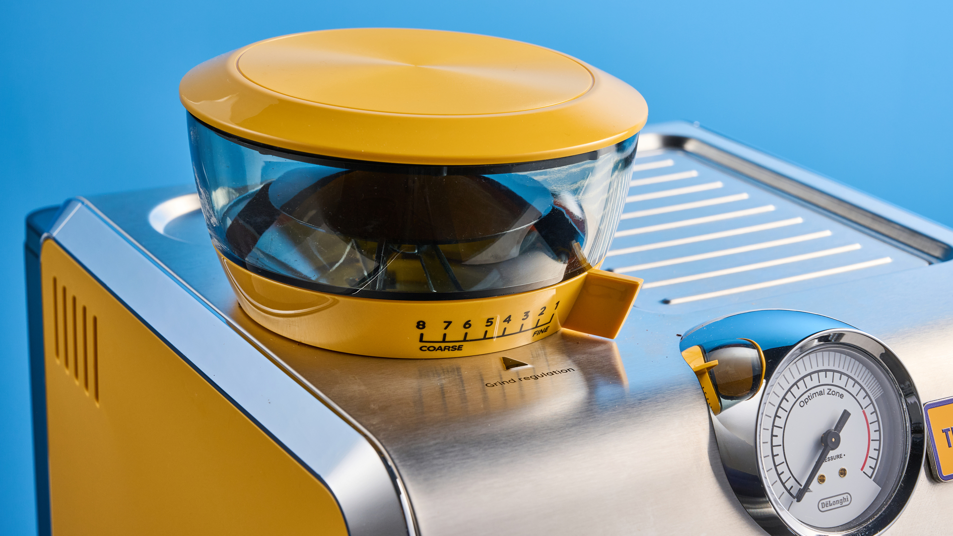 the de&#039;longhi la specialista arte evo special edition truestart edition, with yellow body, showing the espresso machine attachments like tamper, tamping collar, grinder, and control buttons