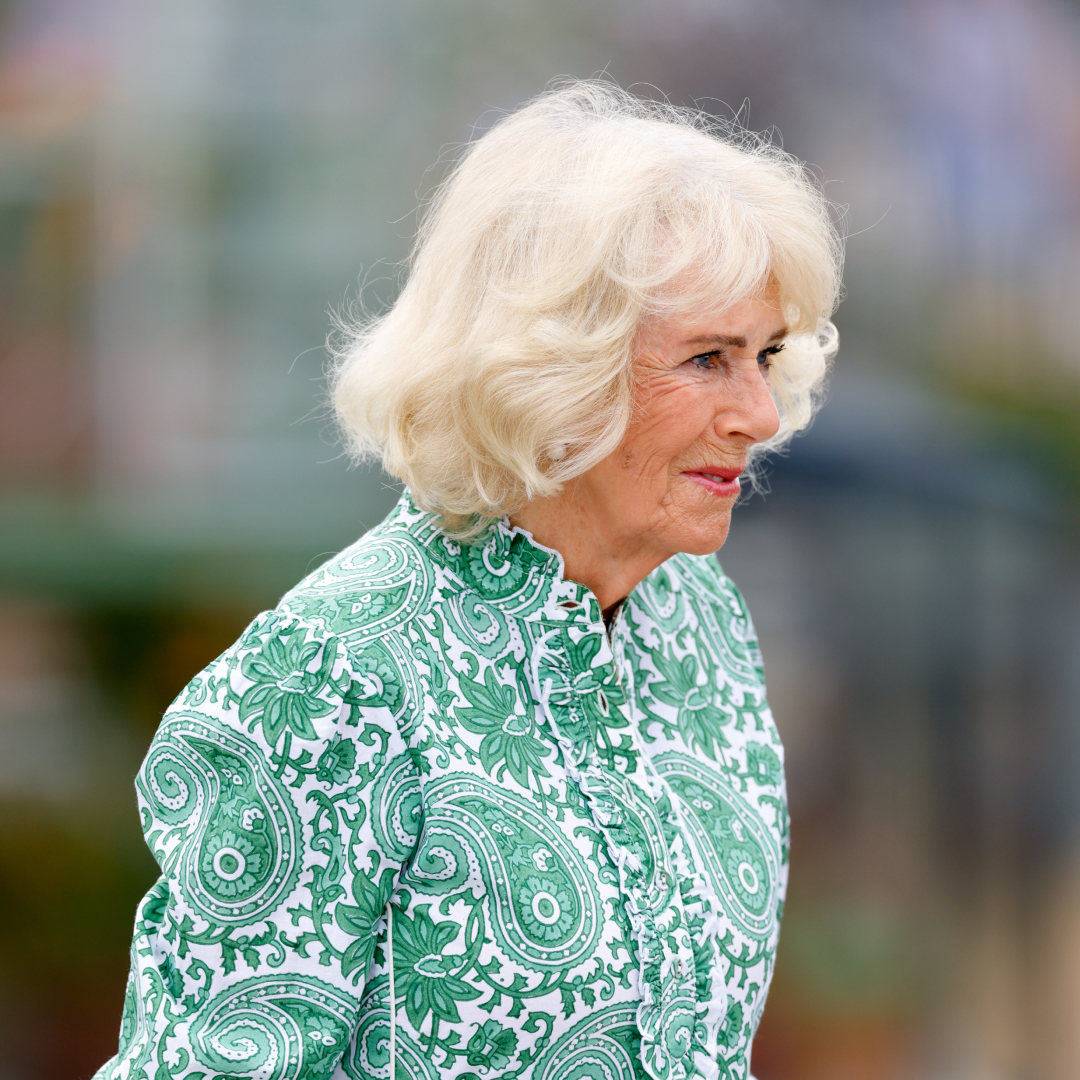 Queen Camilla turned to the side wearing a green dress