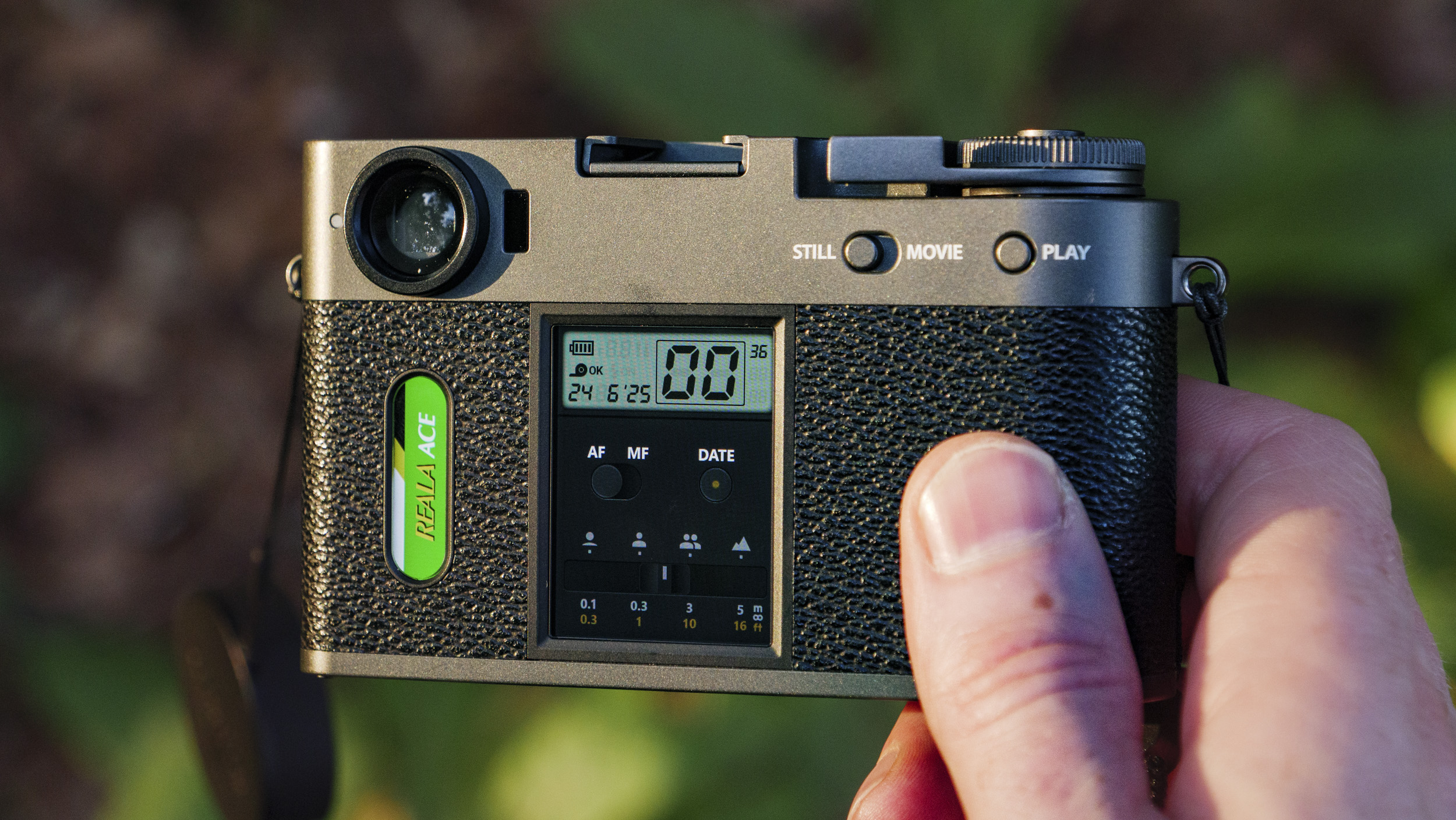 Fujifilm X half camera in the hand at golden hour