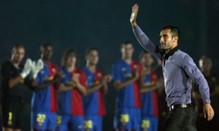 Barcelona coach Pep Guardiola waves to the fans at the Gamper Trophy game against Boca Juniors in 2008.