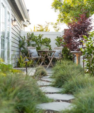 side yard with stepping stone path and seating designed by Sacha McCrae of Living Gardens Landscape Design