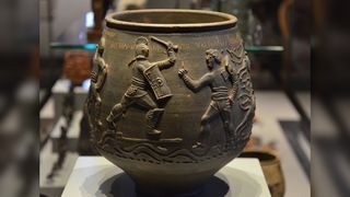 The Colchester vase on display at Colchester Castle Museum in the U.K. The vase has a scene of two fighting gladiators. 