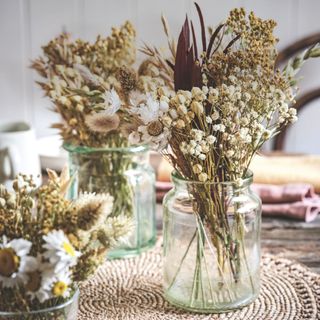 Dried flower bunches in empty jam jars