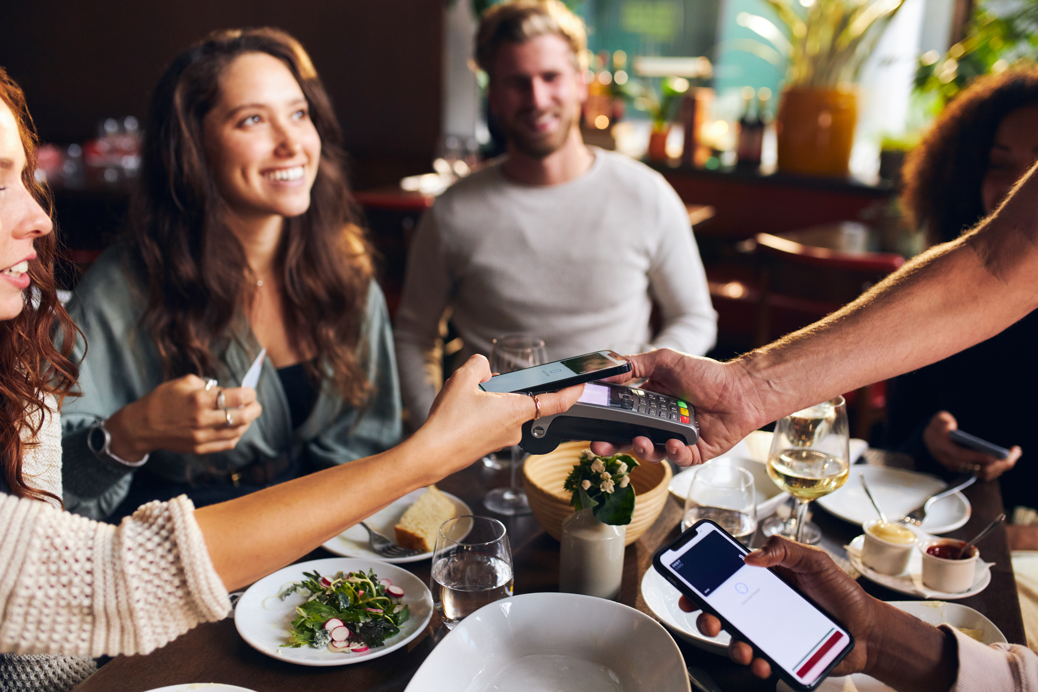 Friends tipping in restaurant
