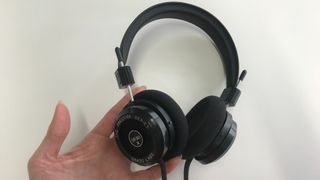 Grado SR80x held in a hand on white table
