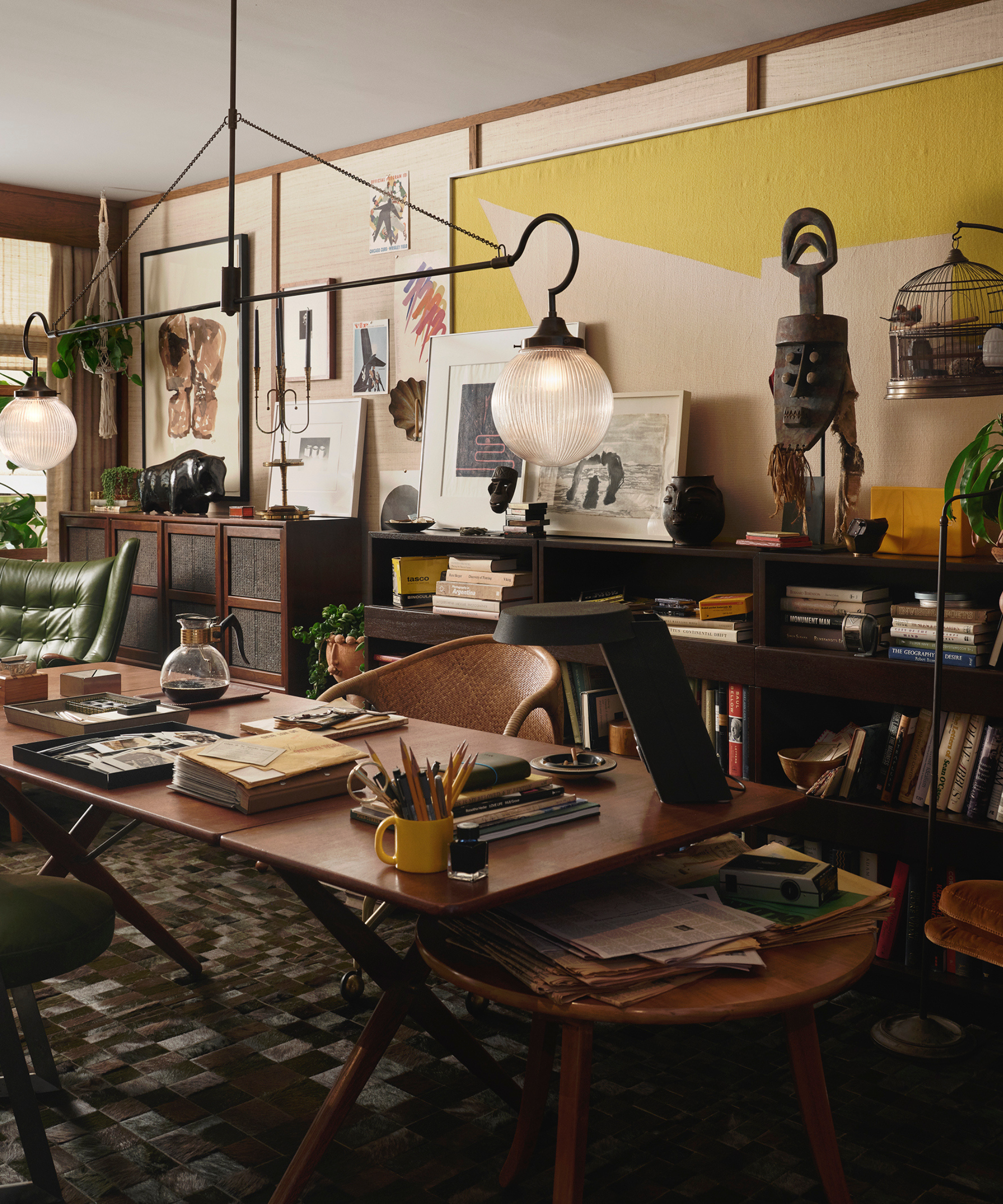 Eclectically moody 60-inspired NYC living room scattered with personal objects and mementos.