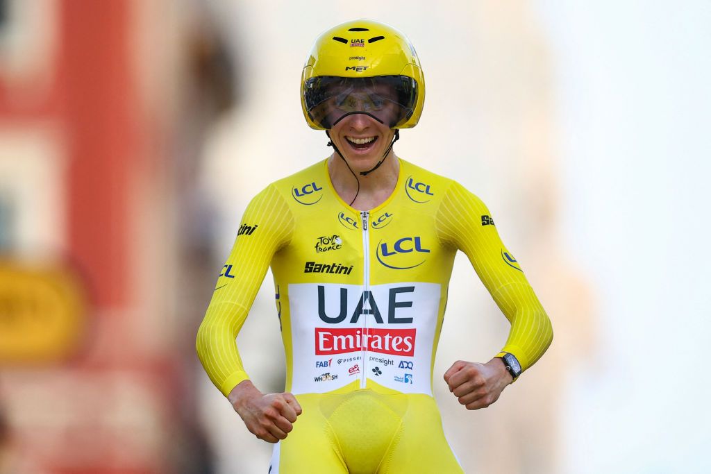 UAE Team Emirates team's Slovenian rider Tadej Pogacar wearing the overall leader's yellow jersey celebrates as he crosses the finish line to win the 21st and final stage of the 111th edition of the Tour de France cycling race, a 33,7 km individual time-trial between Monaco and Nice, on July 21, 2024. (Photo by Anne-Christine POUJOULAT / AFP)