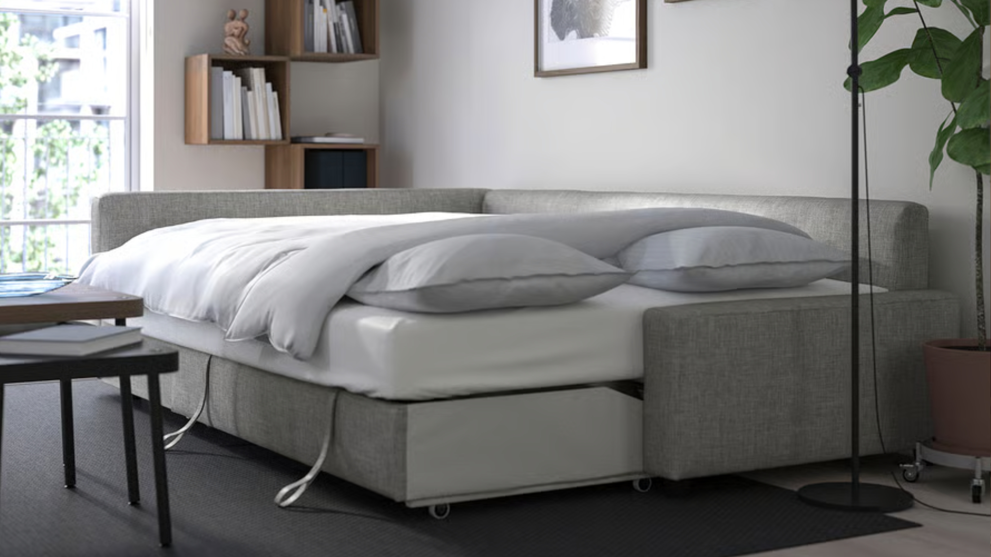 ikea grey sofa bed folded out in a living room 
