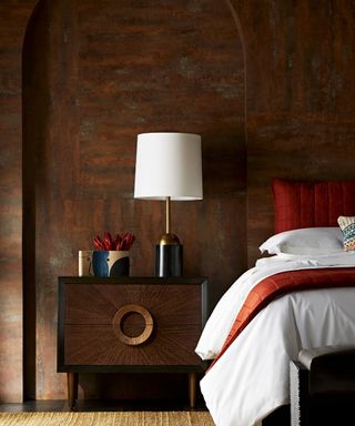 A bedroom furniture idea with modern wooden bedside table against natural wood panelled wall