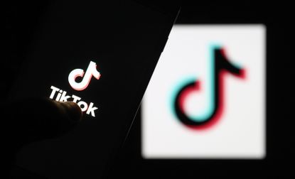 logo of TikTok is displayed on a smartphone and a pc screen in Ankara, Turkey on May 11, 2021.