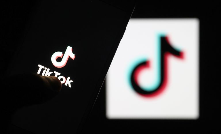 Logo of TikTok is displayed on a smartphone and a pc screen in Ankara, Turkey on May 11, 2021.