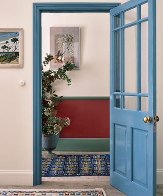 Farrow & Ball hallway with blue door and red / green corridor paint decor