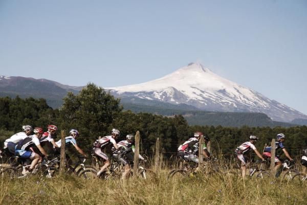 Racers pass beautiful Andes mountain scenery.