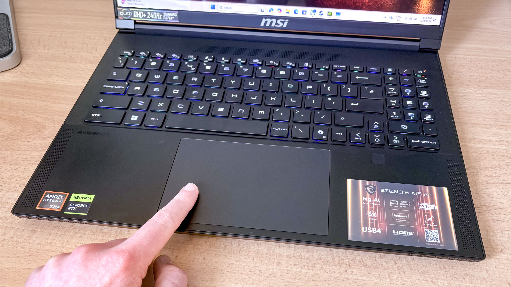 MSI Stealth A16 AI+ keyboard and touchpad with finger on pad