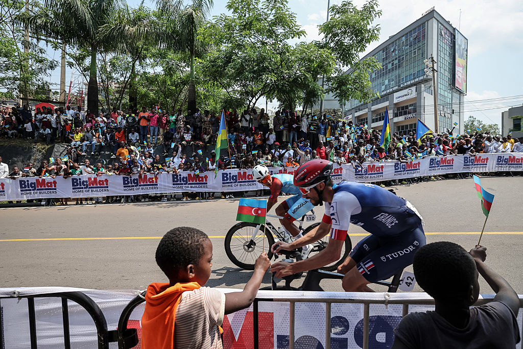Mongolian rider Tegshbayar Batsaikhan (L) and French rider Julian Alaphilippe (R) competes in the men&#039;s Elite road race cycling event during the UCI 2025 Road World Championships, in Kigali, on September 28, 2025. (Photo by Anne-Christine POUJOULAT / AFP)