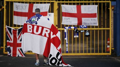 A Bury FC supporter outside the club’s Gigg Lane ground