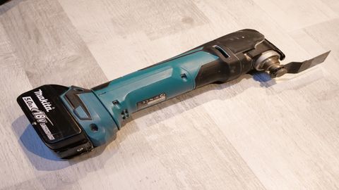 Makita DTM51Z cordless multi tool on wood floor