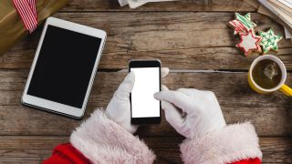 Santa Claus uses his smartphone