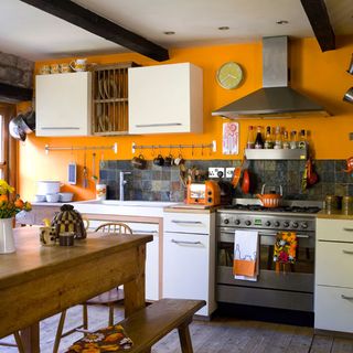 kitchen with wooden flooring and orange wall