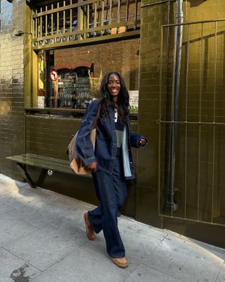 Woman wears brown cardigan and blue jeans