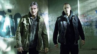 (L-R) Liam Neeson as Jimmy 'The Gravedigger' Conlon and Joel Kinnaman as Mike Conlon in "Run All Night"