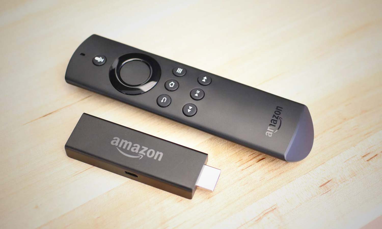 The Amazon Fire TV stick and its remote on a table